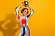 Photo of beautiful model woman retro style outfit dance demonstrate hands raised up disco ball carnival isolated on yellow color background