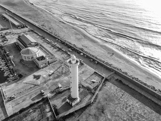 Wall Mural - Aerial view from drone of lighthouse near harbor entrance