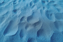 Top View Of Blue Sand, Captured In Close-up Detail, Displaying Textured Grains.