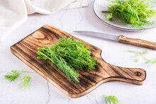 A Bunch Of Dill On A Cutting Board On The Table. Organic Natural Seasoning.