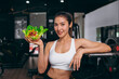 © Quality Stock Arts - sport healthy beautiful asian woman showing vegetables mix salad for diet food low calories in fitness sport club