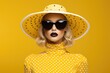 A woman wearing a yellow hat and sunglasses