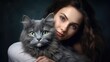 © tpvisuals - Heartwarming bond between Maine Coon kitty cat and pretty female owner sharing a gentle hug. Close-up portrait on a dark background.