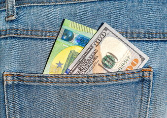 Wall Mural - Euro and american banknotes sticking out of the back jeans pocket