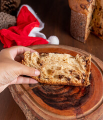 Wall Mural - Woman taking slice of delicious Panettone cake closeup