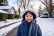 © Baba Images - Portrait of a happy young girl outside during winter