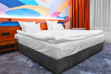 Poster - Interior of a modern bedroom in an apartment, hotel or private house with a bed and pillows