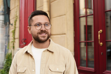 Poster - Portrait of handsome bearded man in glasses outdoors, space for text