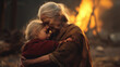 A sad elderly woman hugs a frightened little girl against the backdrop of a fire. A grandmother consoles a child in the ruins of a destroyed house. People's emotions from losses, disaster. Copy space