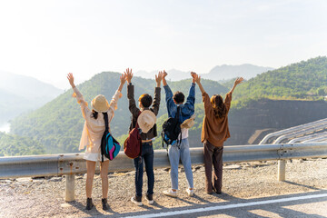 Wall Mural - Group of Asian generation z people friends looking beautiful nature of countryside forest and mountain. Man and woman friendship enjoy and fun outdoor lifestyle road trip on summer holiday vacation.