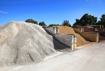 Large quantities of different landscaping rocks, recycled concrete, stones, sand and fill for sale at a local supply shop.