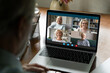 © fizkes - Communication on retirement. Aged male using laptop to talk with old friends retired persons online in video conference app discuss news chat about common interests. Over shoulder view on pc screen