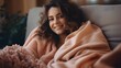 Woman relaxing in a cozy blanket, a moment of comfort and peace, peach fuzz color
