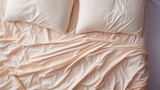 Fototapeta  - Elegant satin sheets in soft light, luxury and sophistication in the bedroom, peach fuzz color tones