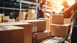 © The Stock Photo Girl - A worker handling boxes in a warehouse