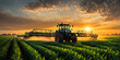 © Smile Studio AP - Tractor Spraying Pesticides on cornfield Plantation at Sunset.