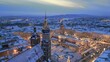 Krakow winter Main Market Square covered with snow aerial drone view of monuments - Saint Mary Church, Sukiennice (Cloth Hall), City Hall Tower, Wawel