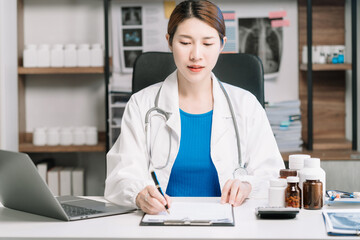 Wall Mural - Doctor working on laptop computer and tablet and medical stethoscope on clipboard on desk, electronics medical record system EMRs concept.