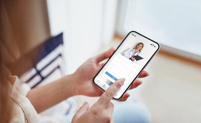 female exploring options on health app via her smartphone at home