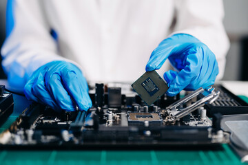 Wall Mural - The technician is putting the CPU on the socket of the computer motherboard. electronic engineering electronic repair, electronics measuring and testing, repair..