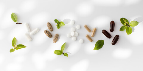 Various vitamins, tablets and dietary supplements with natural formulations on a white background.