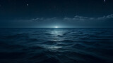 Fototapeta Morze - Moonlight reflecting on the calm ocean surface at night.