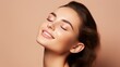 skincare beauty model woman face with healthy skin and natural makeup, happy young adult girl with closed eyes on beige background, spa concept