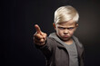 Angry child pointing his finger. The concept of child aggression, anger and hatred