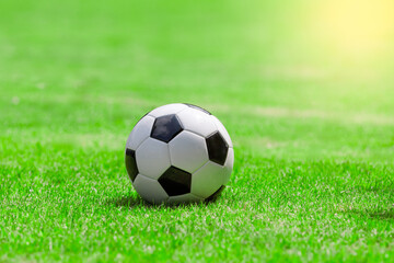  An empty soccer ball on the grass Outdoors with a blurred green garden background, park on a sunny day. warm with sunset light
