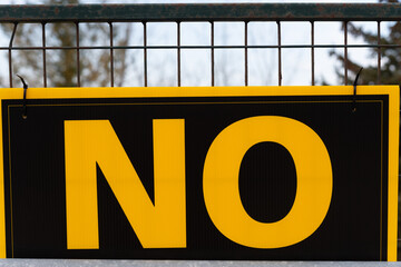 close-up of a no sign on a fence