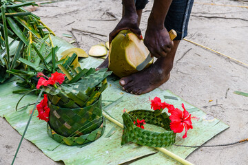 Wall Mural - Young man peeling coconut fruit at the farm at Zanzibar island