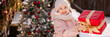 © Kaplitskaya Love - Little girl with a Christmas gift outdoors in winter on Christmas Eve. New Year background for holiday sale or promotion. Banner with copy space.