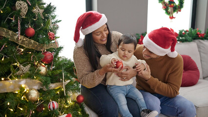 Wall Mural - Couple and son decorating christmas tree at home