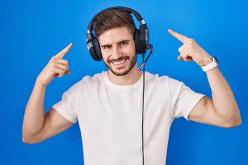 Poster - Hispanic man with beard listening to music wearing headphones smiling pointing to head with both hands finger, great idea or thought, good memory