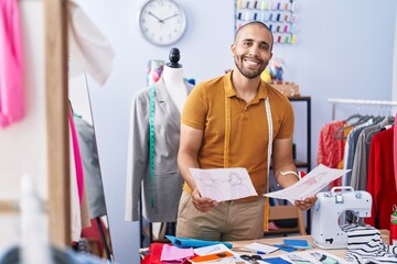 Canvas Print - Young latin man tailor smiling confident looking clothing design at park