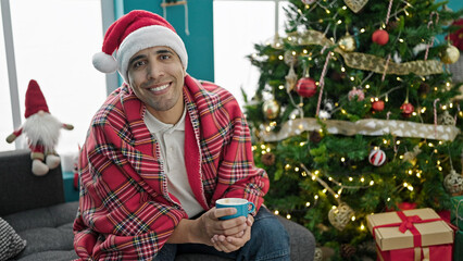 Poster - Young hispanic man drinking coffee celebrating christmas at home