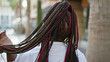 © Krakenimages.com - Beautiful african american woman stands outdoors on sunny city street, touching her hair backwards - an expression of urban elegance, viewed from behind.