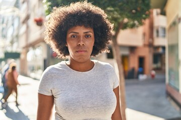 Poster - African american woman standing with serious expression at street