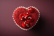 A heart shaped red velvet cupcake against a burgundy red fading background