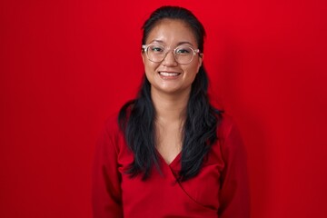 Sticker - Asian young woman standing over red background with a happy and cool smile on face. lucky person.