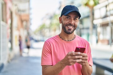 Sticker - Young bald man smiling confident using smartphone at street