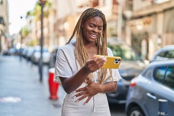 Sticker - African american woman smiling confident watching video on smartphone at street