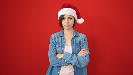 Young caucasian woman standing upset wearing christmas hat over isolated red background