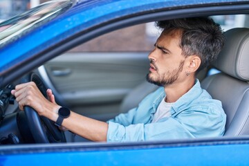 Poster - Young hispanic man stressed driving car at street