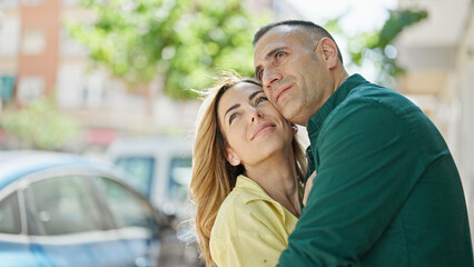 Poster - Man and woman couple hugging each other smiling at street