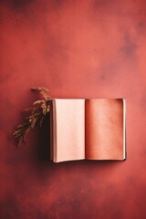 Wall Mural - An open book on a red background with some dried grass, AI