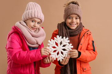 Poster - Cute children in winter clothes on beige background