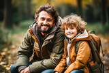 Fototapeta  - Father and son pack their backpacks before leaving for a hike in a clearing.