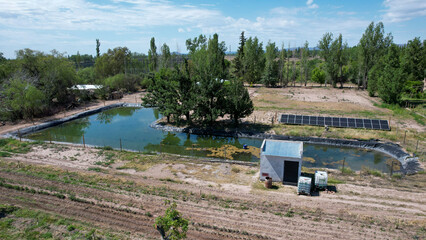 Wall Mural - Water pool, together with solar pumping for field irrigation. Water care.