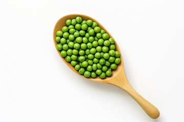 Top view of a wooden spoon with green peas isolated on a white background. Healthy vegetarian food, rich in protein and vitamins. Perfect for cooking, recipe or food related content.